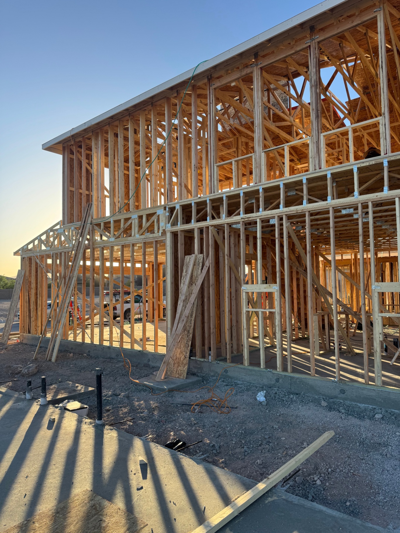 Two-story residential framing at sunset